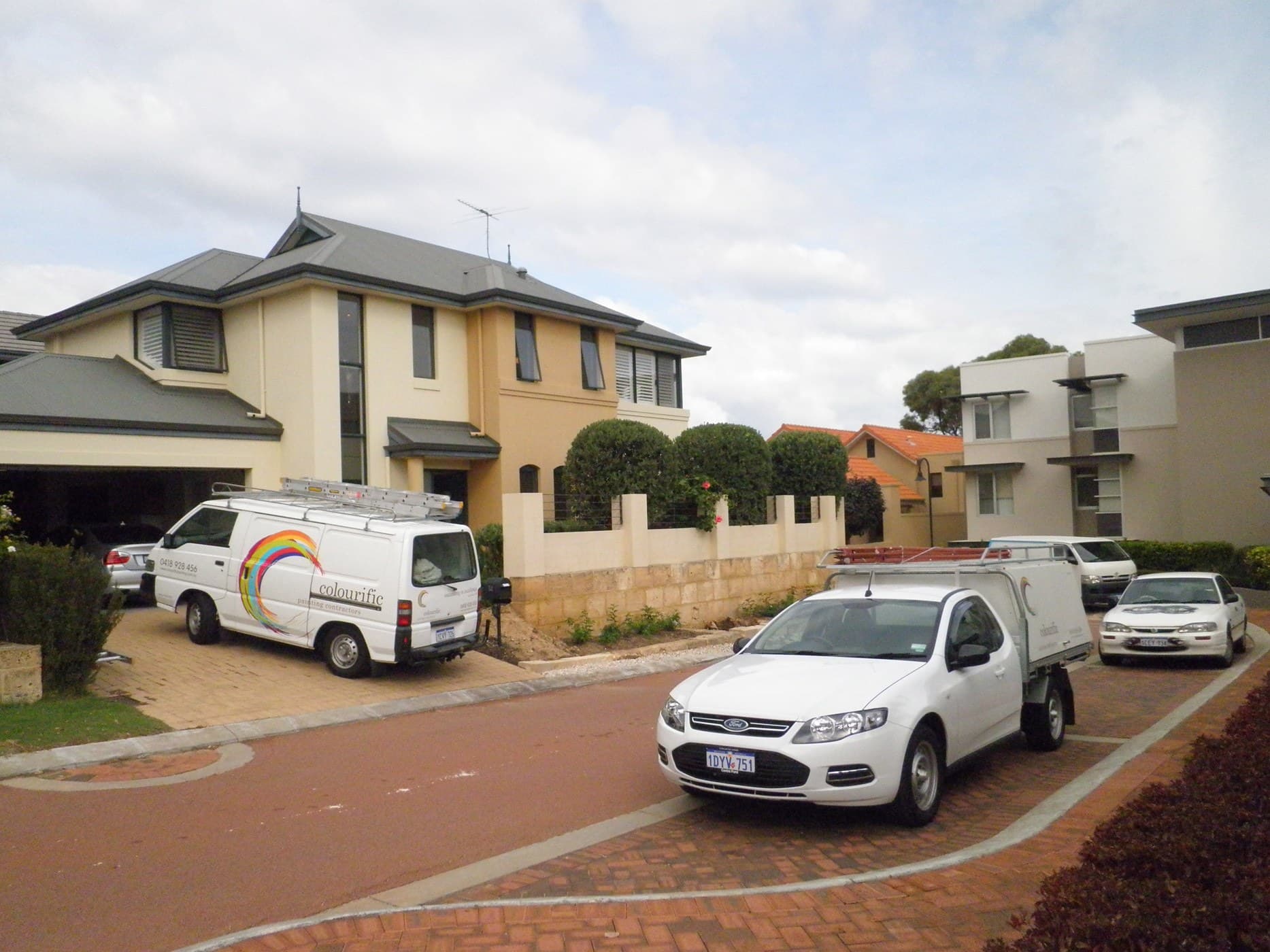 Colourific Painting vans parked at a house